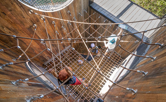 Top-down view of five young guests at the Leopard Playground.