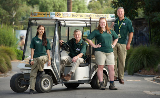 Four volunteers stand proudly with their buggy at Melbourne Zoo.