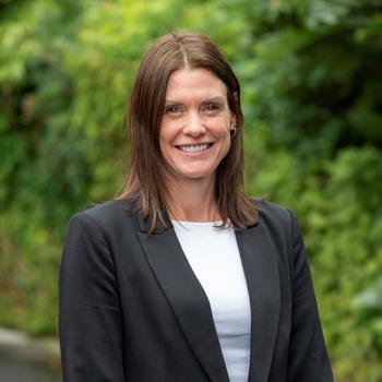 Dr Jennifer Beer smiling at camera