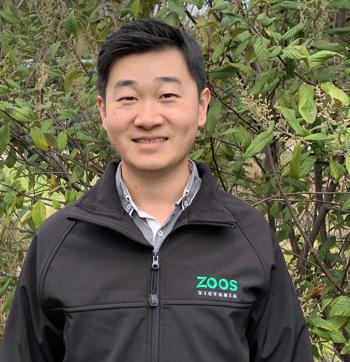 Portrait of Vet Tian, in front of a leafy backdrop.
