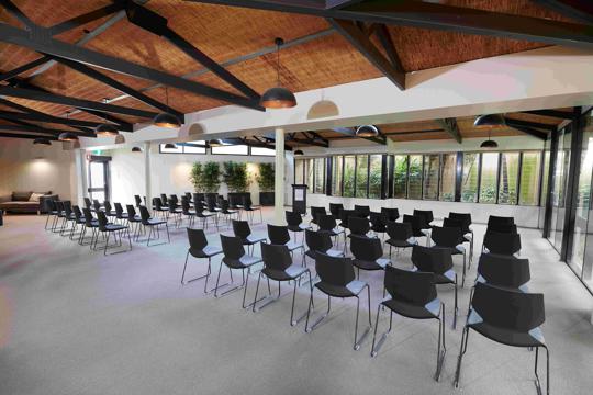 View of the Bong Su Room, prepped for a meeting with five rows of chairs.