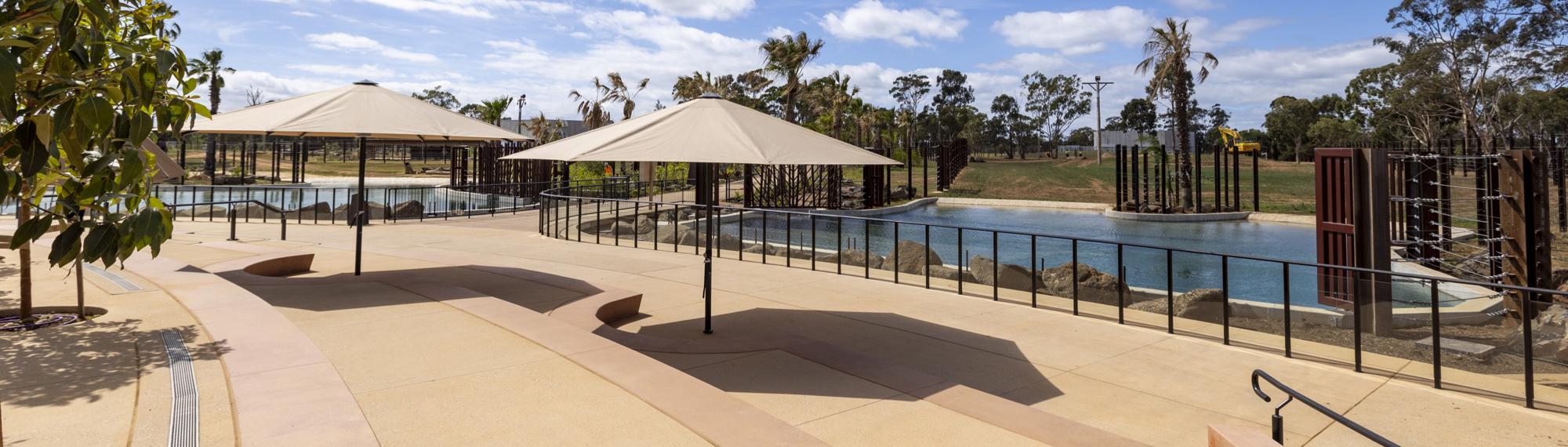 A view of the new Elephant Trail, towards the Elephant Barn, beneath an overcast sky.