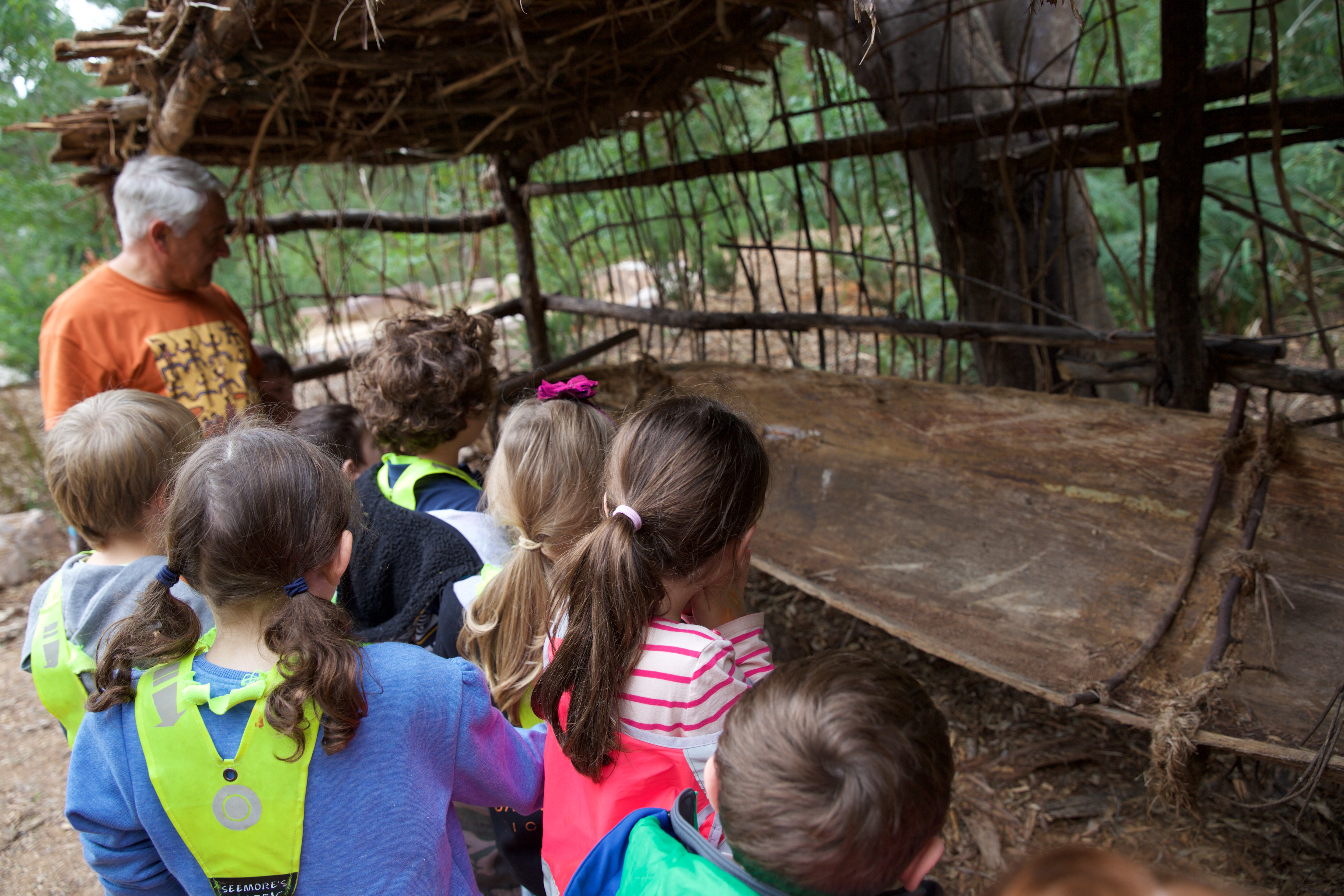 Murrundindi at Healesville Sanctuary showing school students how the bark had been stripped from the Scar tree to be used to make a canoe.