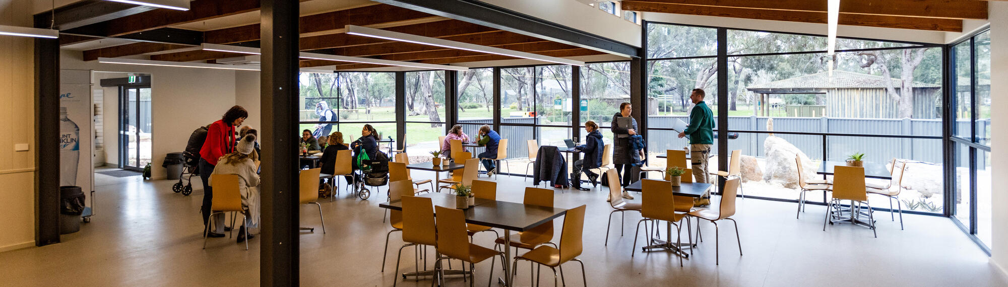 View of the Kyabram Fauna Park Café, with at least eleven guests and one Meerkat.