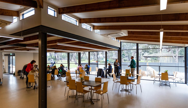 View of the Kyabram Fauna Park Café, with at least eleven guests and one Meerkat.
