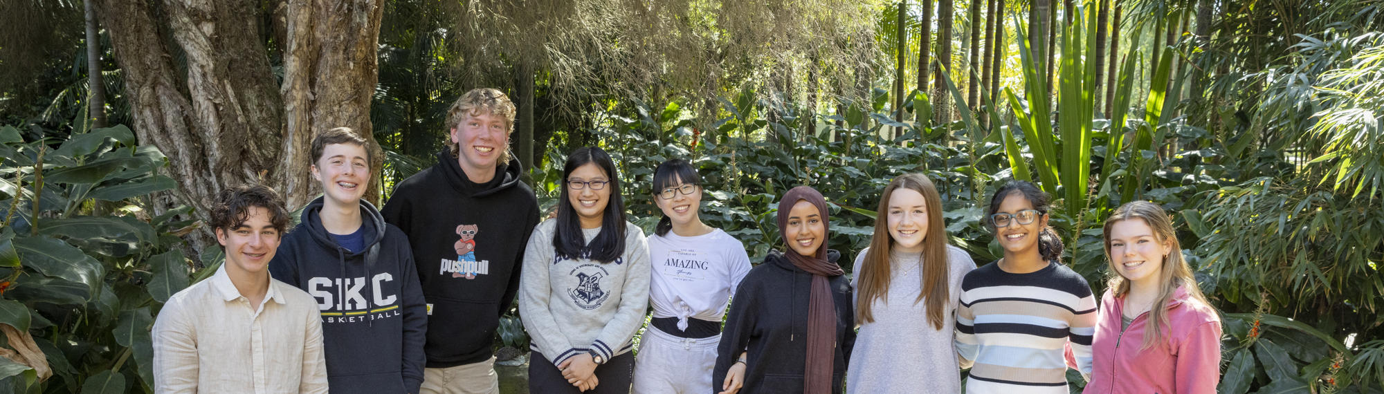 The nine then-active members of ZV's Youth Advisory Committee, rowed up in the Rainforest and smiling to the camera.