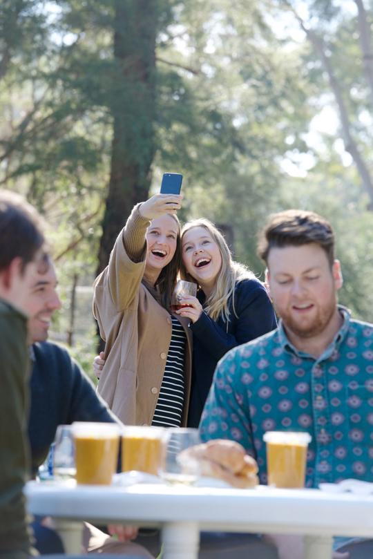 Two young adults smiling, taking selfie