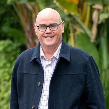Tony Hallam smiling at camera