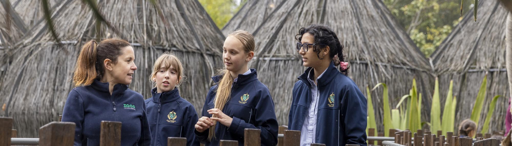 Keeper in conversation with three students at Lemur Island.