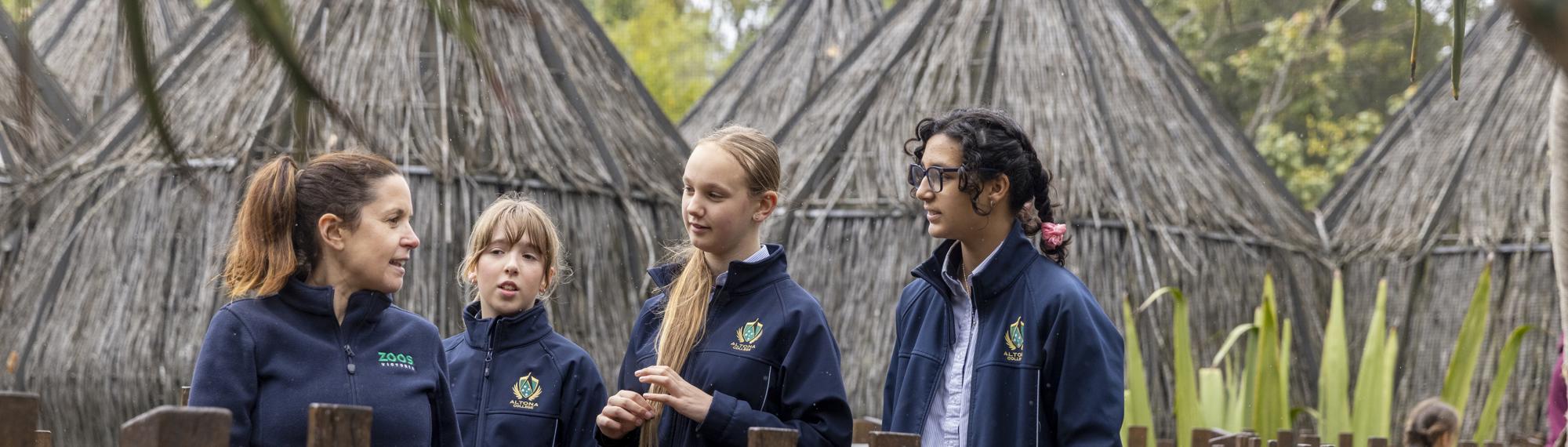 Keeper in conversation with three students at Lemur Island.