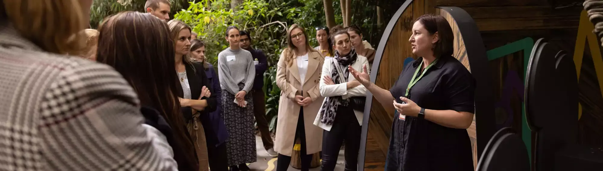 Manager Lian, on the right, talks to some thirteen guests in the Rainforest Trail near the Gorillas.