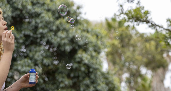 Adult blowing bubbles.