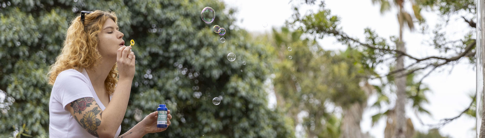 Adult blowing bubbles.