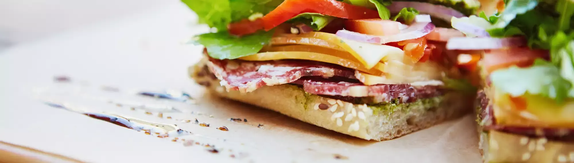Close-up photo of a focaccia cut in two showing various ingredients.