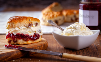 An image of scone with cream and strawberry jam