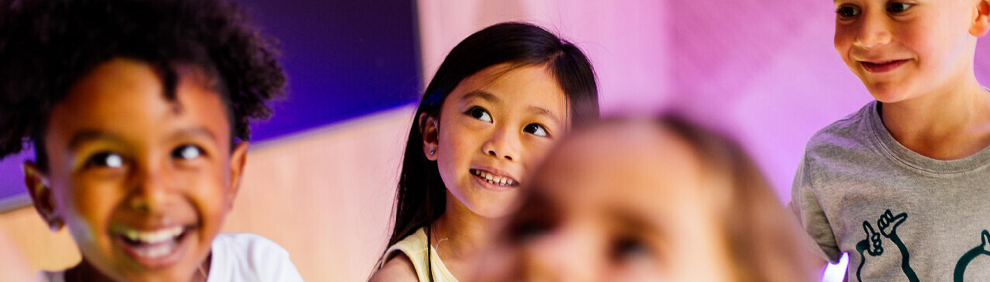 Five young guests happily enjoying themselves in the Frog Disco, while looking left.