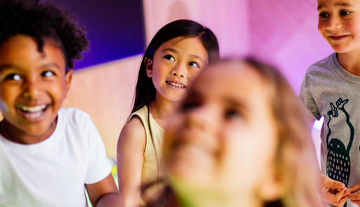 Five young guests happily enjoying themselves in the Frog Disco, while looking left.
