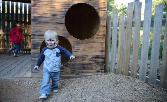 A toddler playing at Corroboree Frog nature play