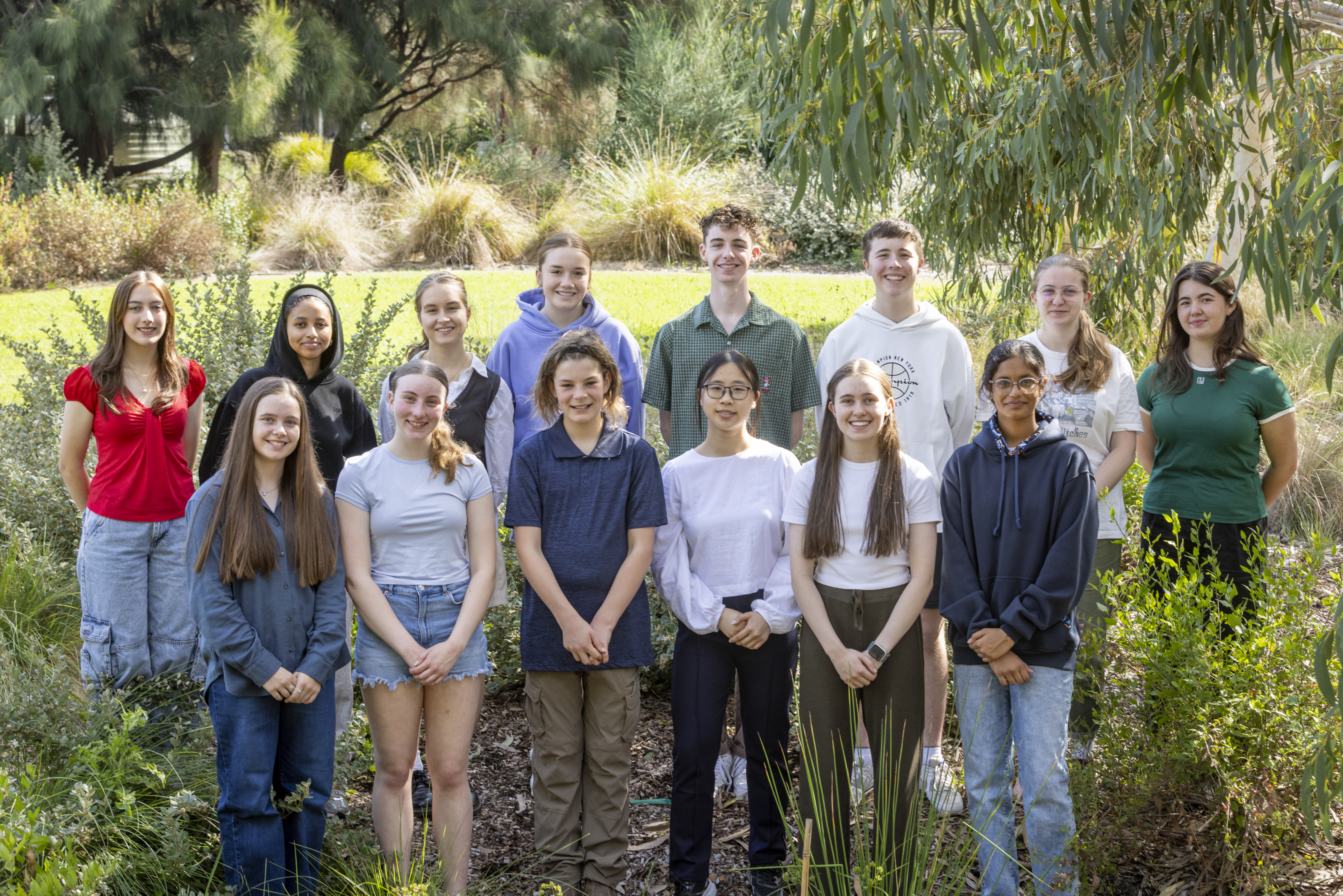 The fourteen active members of the Youth Advisory Committee, posing for a group photo at Melbourne Zoo.