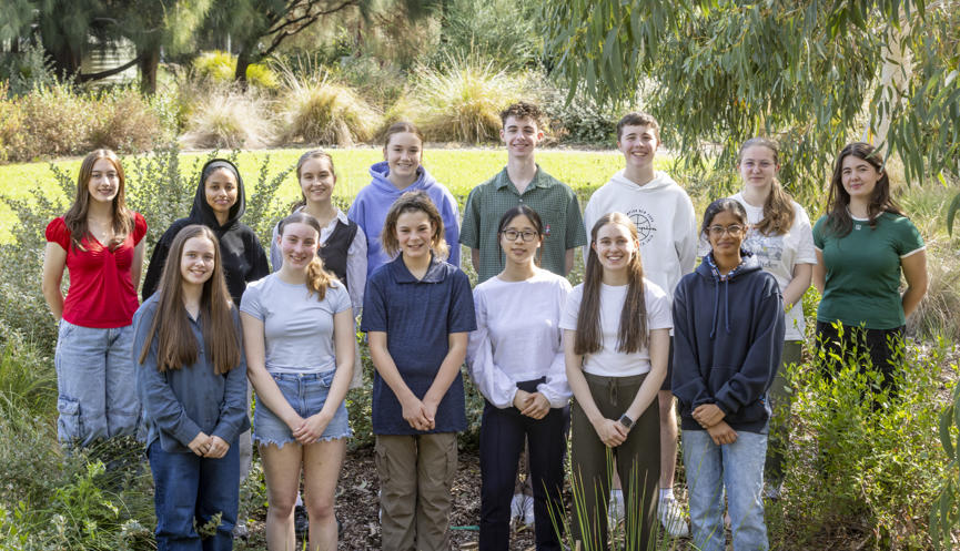 The fourteen active members of the Youth Advisory Committee, posing for a group photo at Melbourne Zoo.