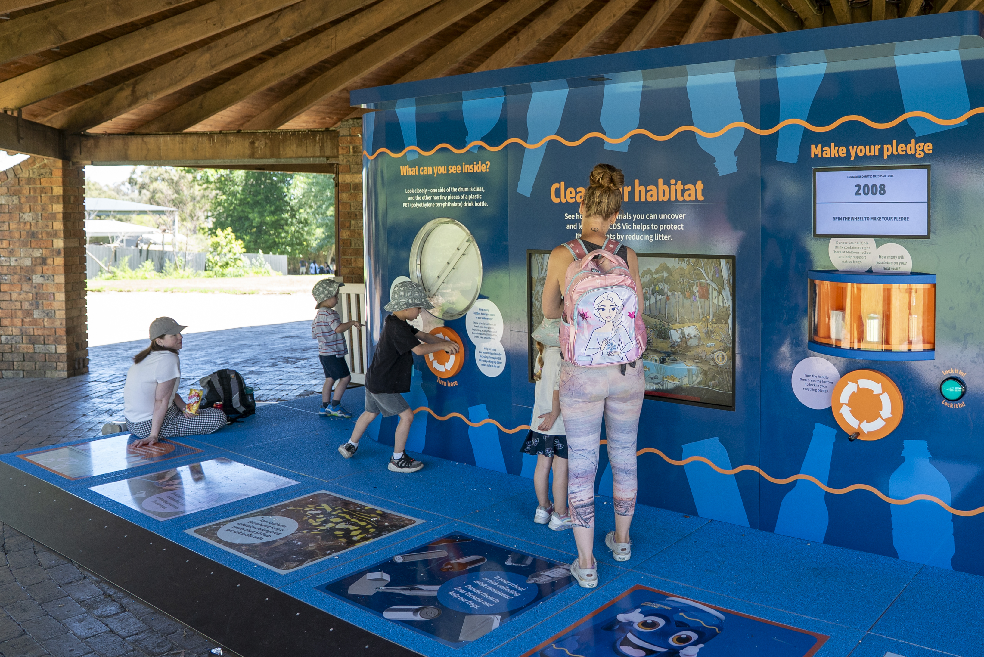 Five guests at the CDS Discovery Station, in the Melbourne Zoo Picnic Pavilion.