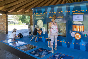 Five guests at the CDS Discovery Station, in the Melbourne Zoo Picnic Pavilion.