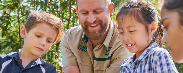 Keeper hosting a talk with four young students.