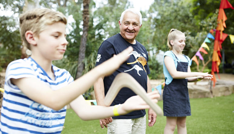 Two kids throwing boomerang with Murrundindi
