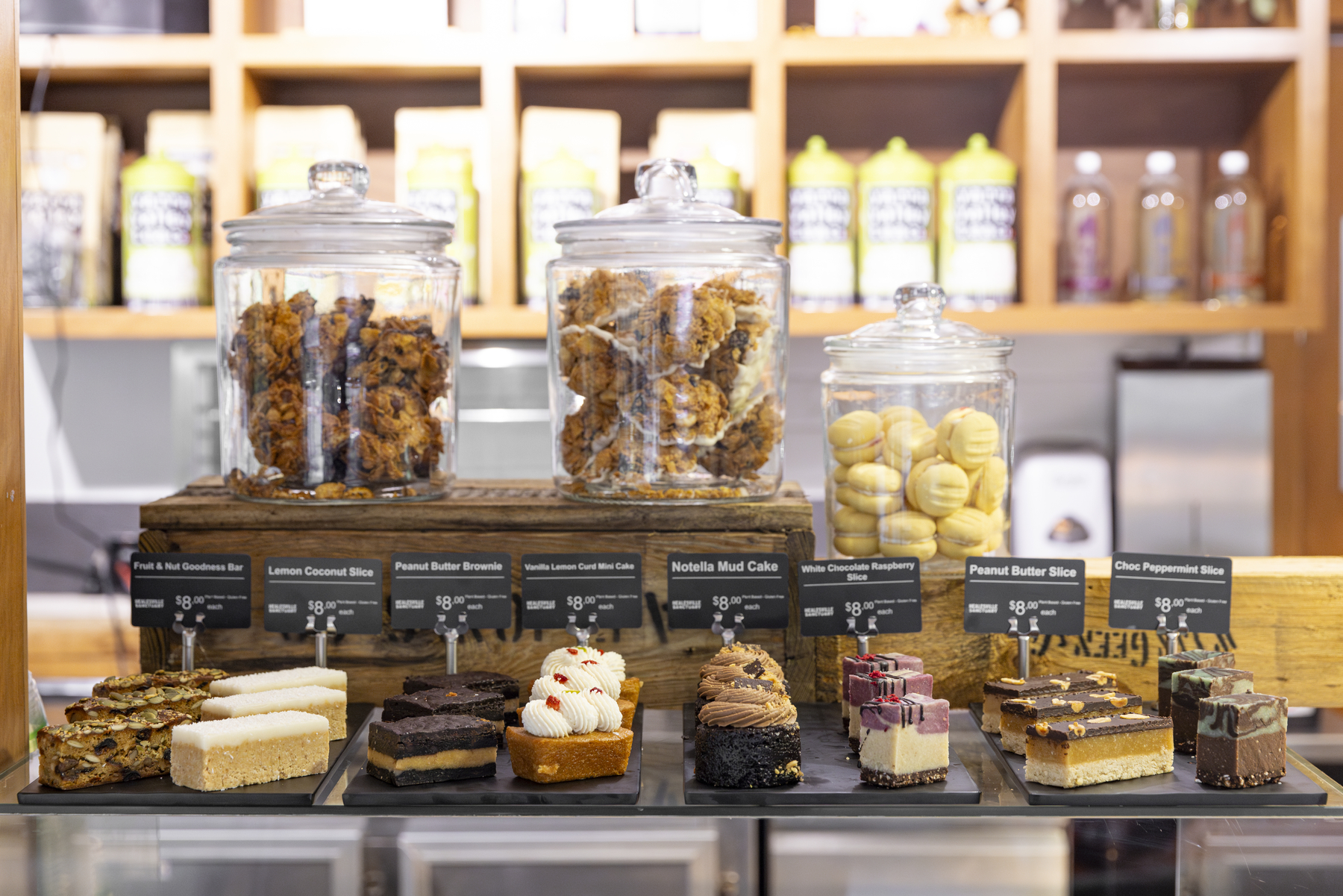 Jars of muffins, cookies and dessert slices on a benchtop in the Sanctuary Harvest Café.