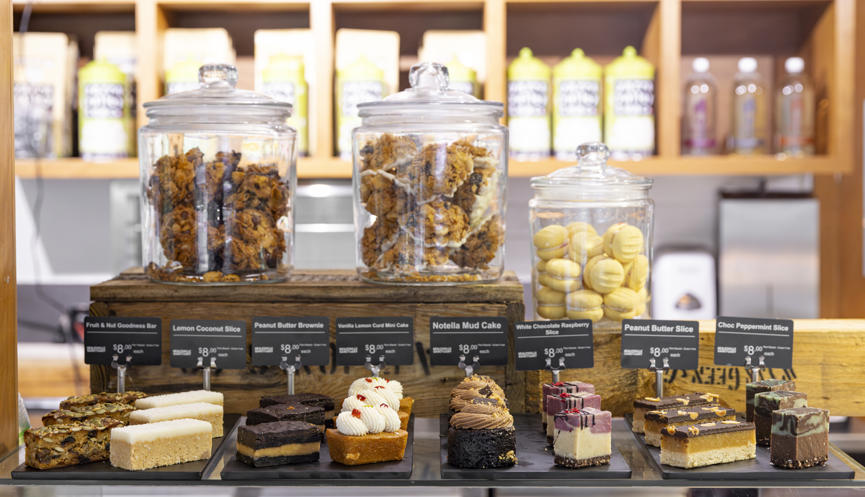 Jars of muffins, cookies and dessert slices on a benchtop in the Sanctuary Harvest Café.