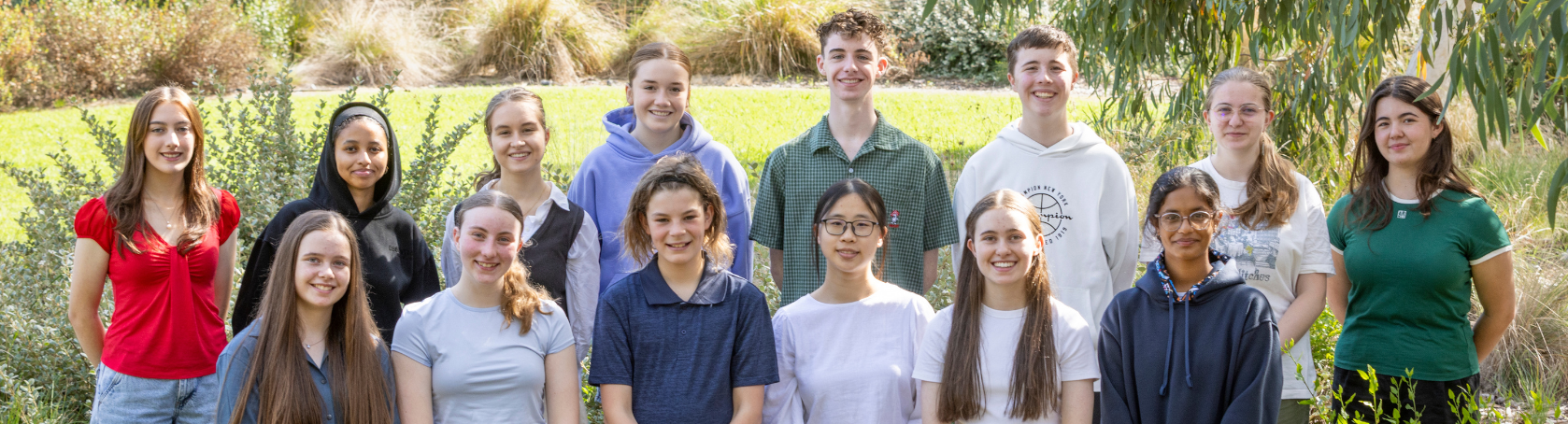 The fourteen active members of the Youth Advisory Committee, posing for a group photo at Melbourne Zoo.