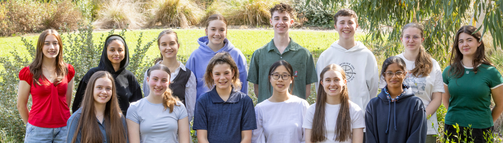 The fourteen active members of the Youth Advisory Committee, posing for a group photo at Melbourne Zoo.