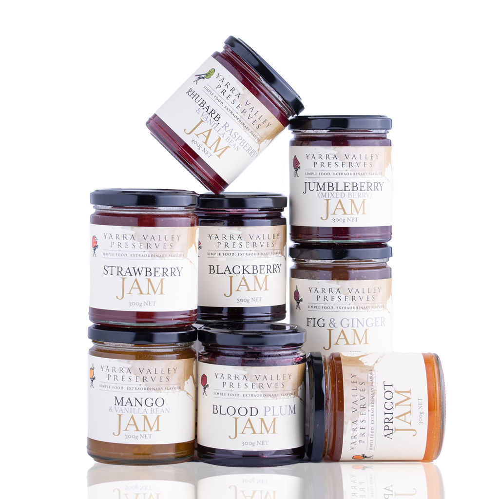 Stack of eight unopened "Yarra Valley Preserves" jars of assorted jams, against a white background.