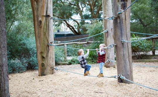Two kids playing on ropes at Bunjil Nature Play.