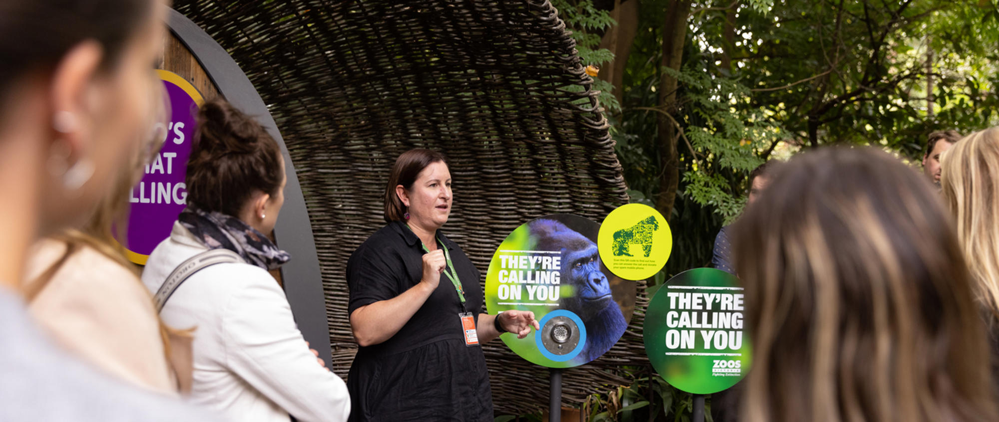 Staffer hosting a talk with at least seven guests at the Gorilla Rainforest.