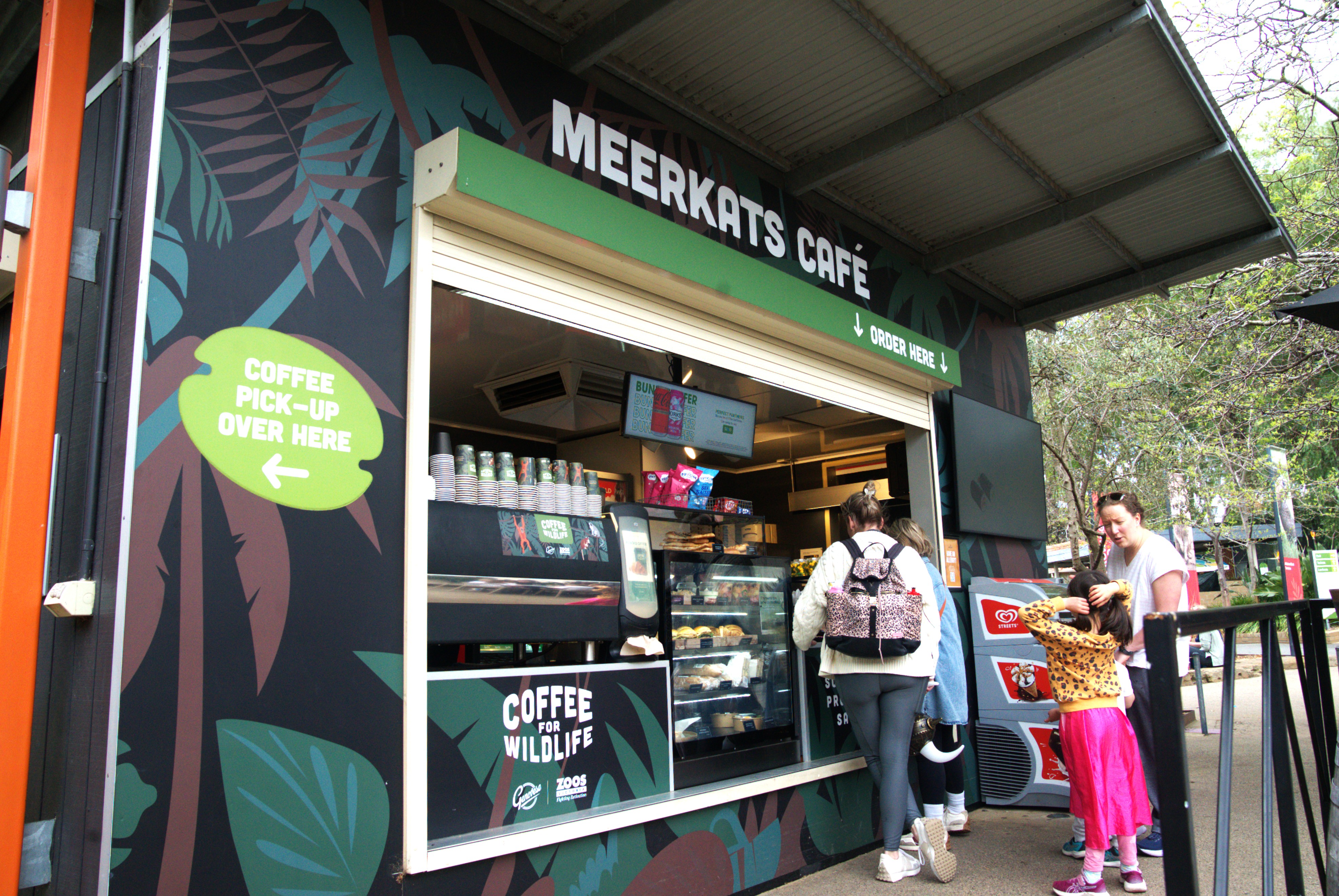 View of the Meerkats Café, with four guests waiting to order.