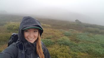 Dr. Marissa taking a "selfie" on a cold foggy plain, smiling in winter wear.