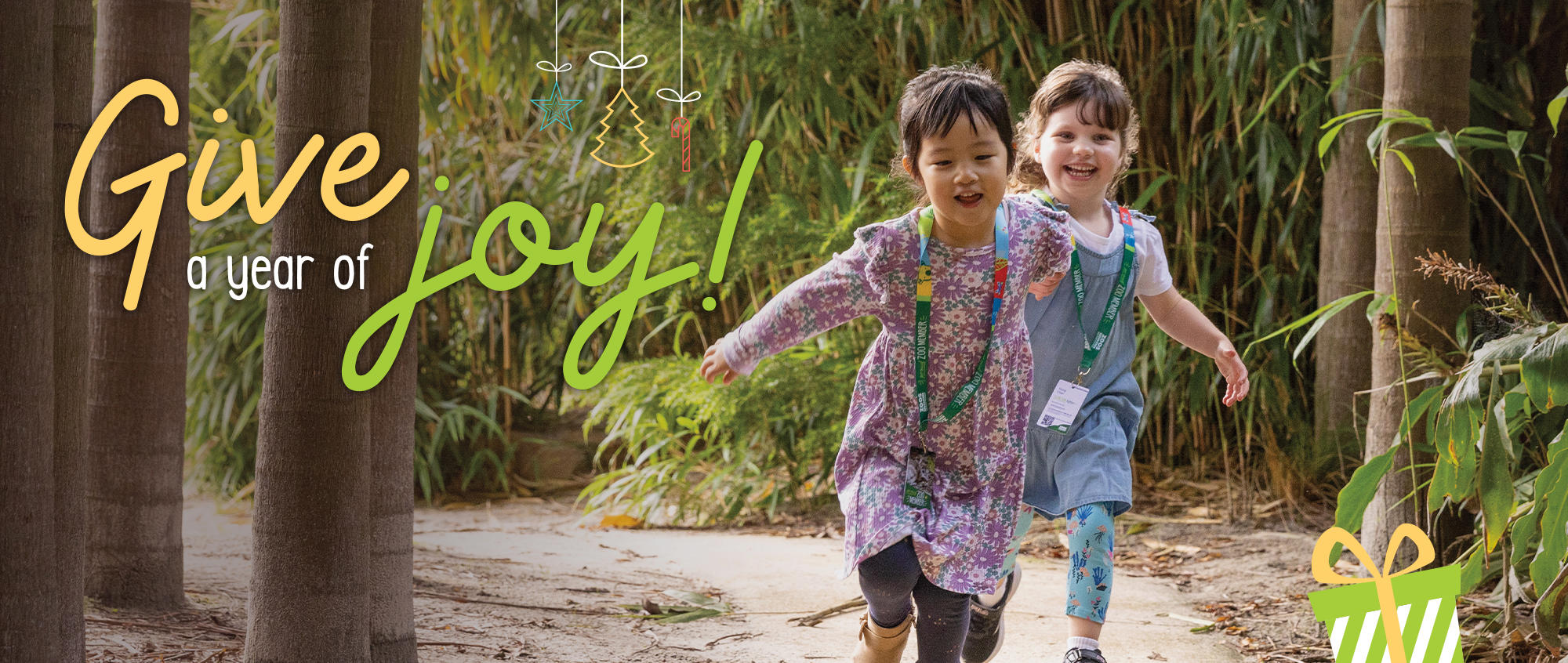 "Give a year of joy!" - Two young guests running through the Bamboo Forest, toward the camera.